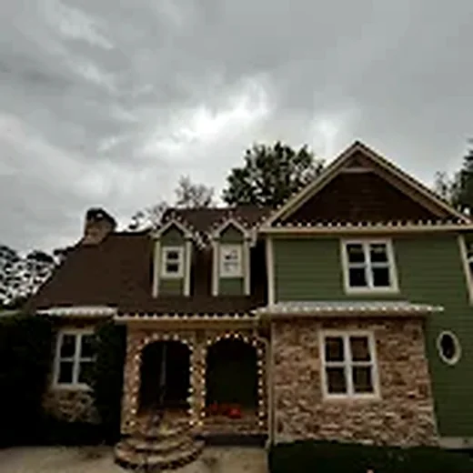 Residential home with roofline and entry Christmas lights